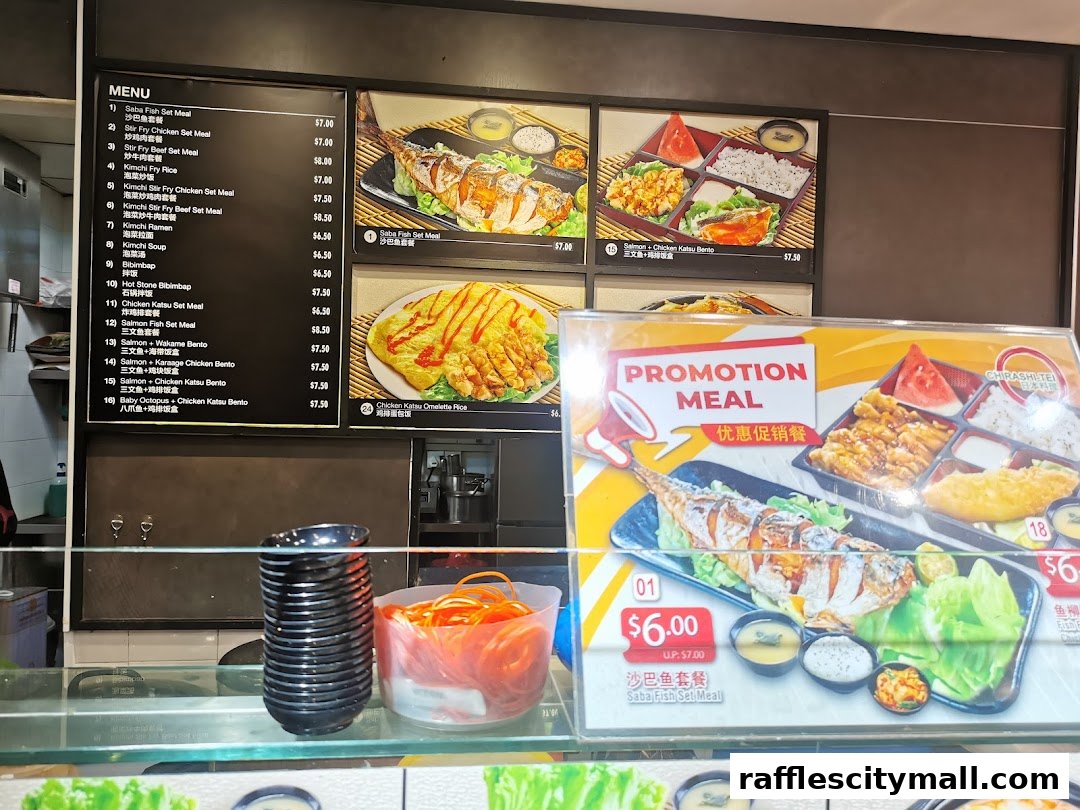 A menu board displaying various Japanese set meals and bentos, with promotional offers.