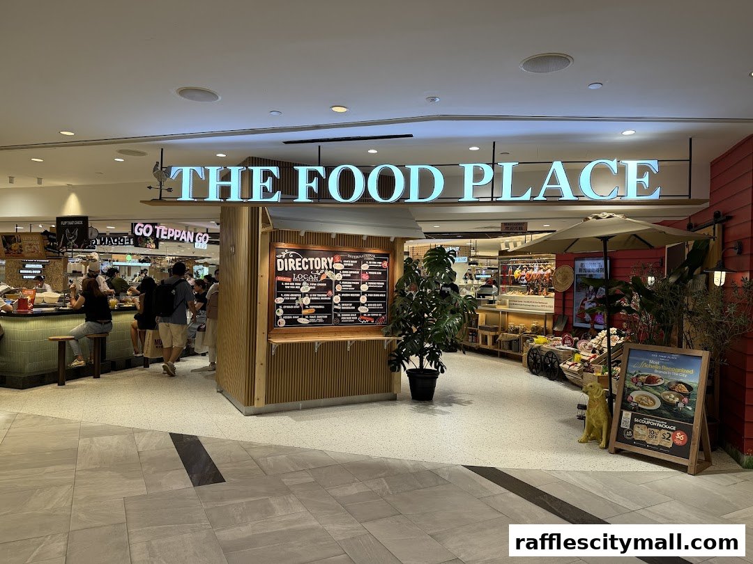 The entrance to 'The Food Place' with a directory board and various food stalls visible inside.
