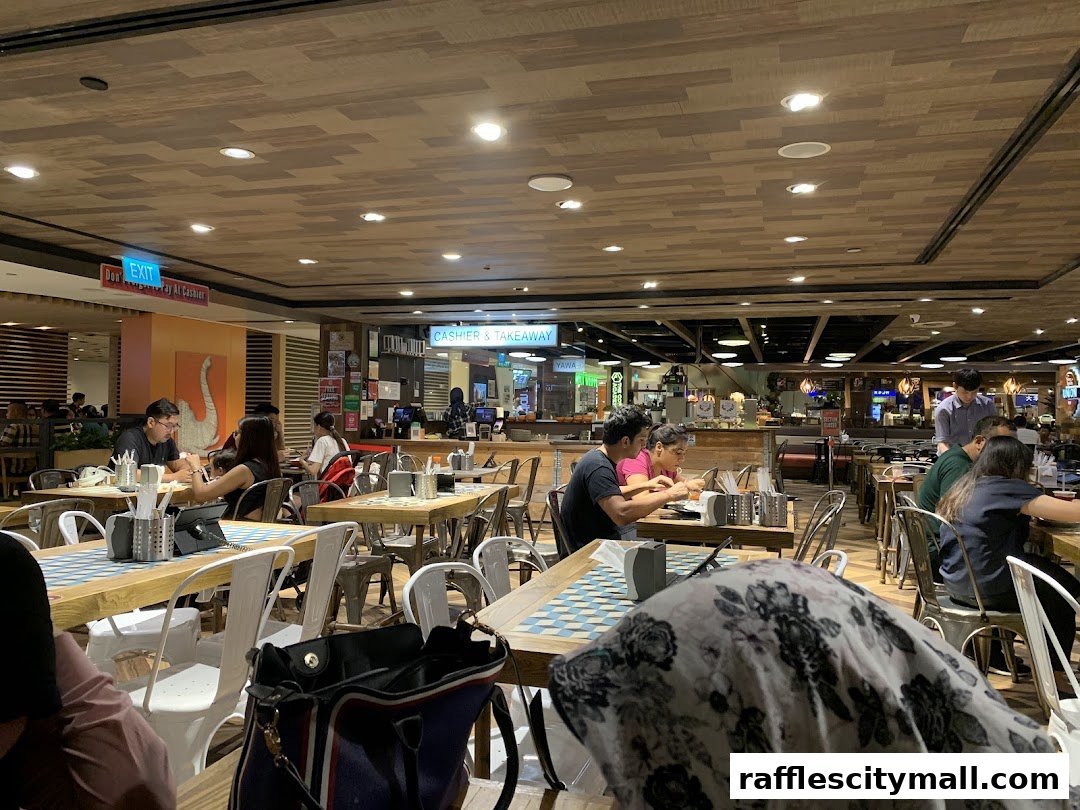 Diners enjoying meals at tables inside a bustling restaurant with a modern, wooden interior.