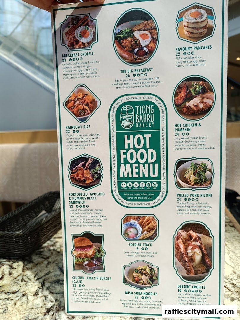 A menu from Tiong Bahru Bakery featuring various hot food items with enticing descriptions and prices.