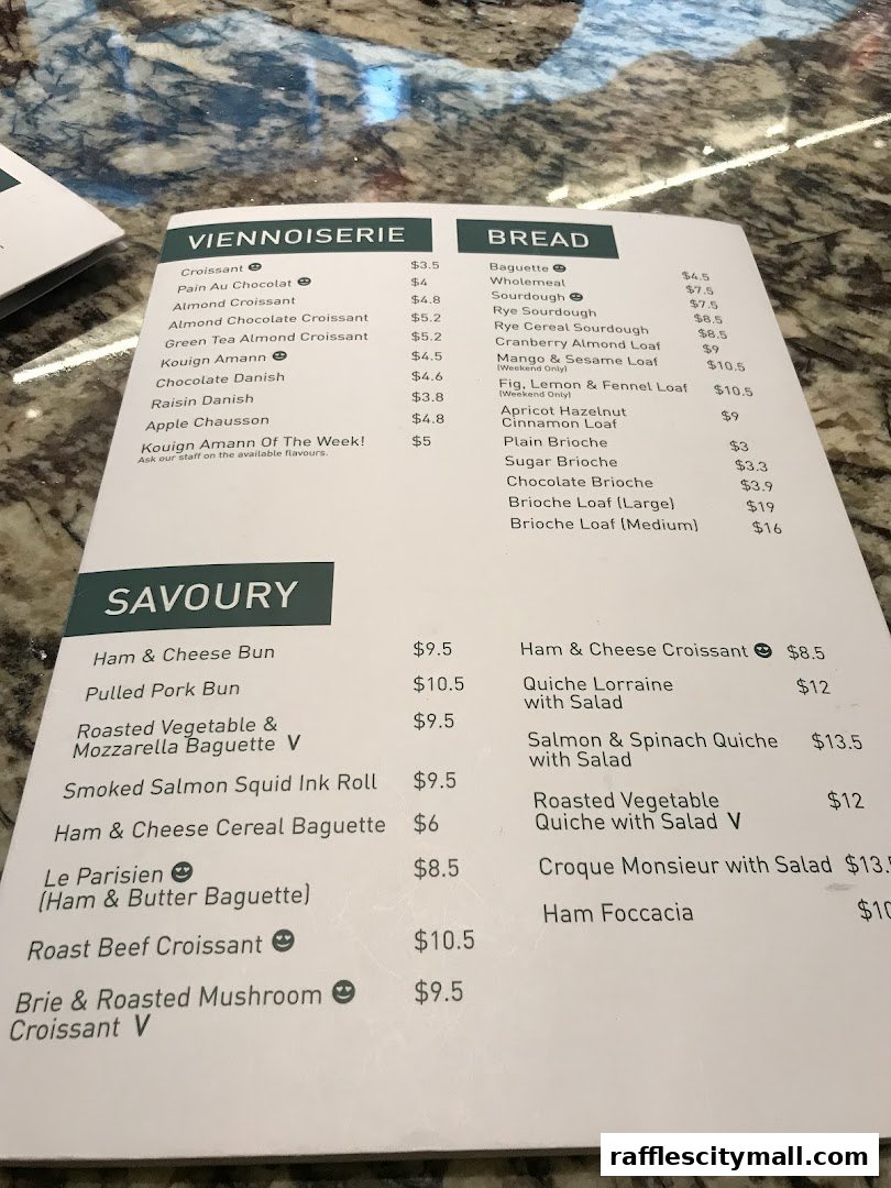 A menu from Tiong Bahru Bakery with categories for Viennoiserie, Bread, and Savoury items.