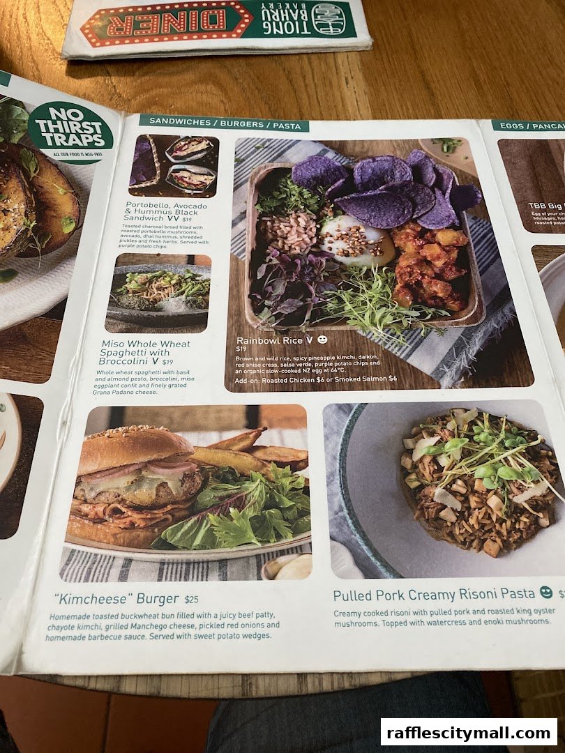 A menu from Tiong Bahru Bakery featuring sandwiches, burgers, pasta, and rice bowls.
