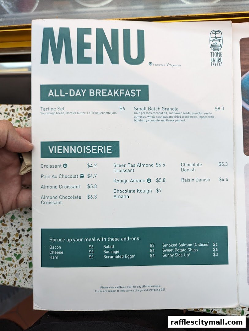 A menu from Tiong Bahru Bakery featuring all-day breakfast and viennoiserie items.