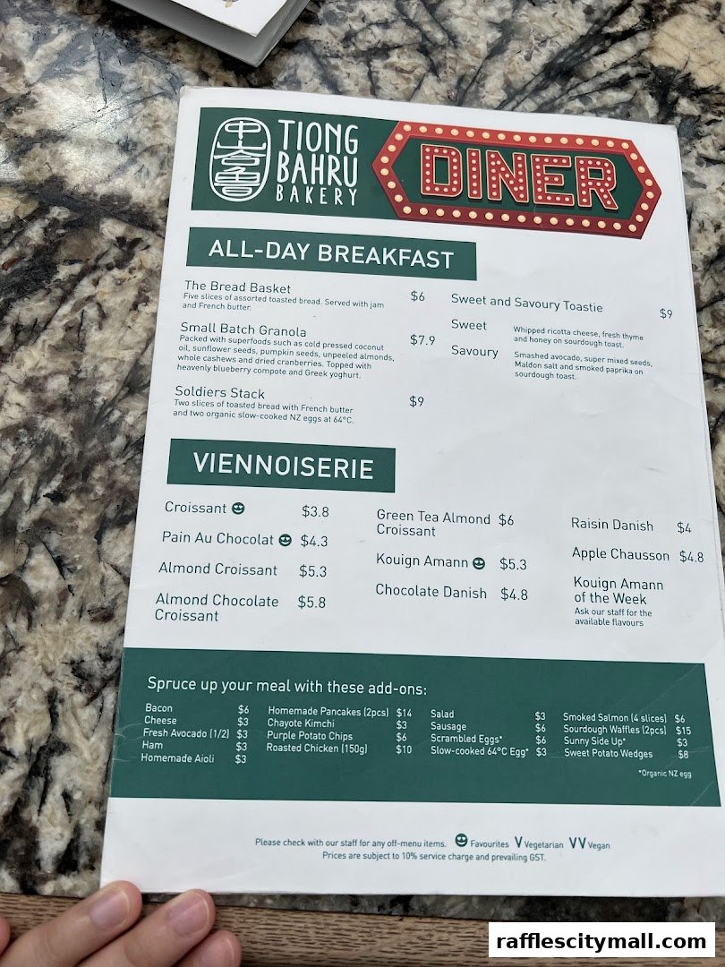 A menu from Tiong Bahru Bakery featuring all-day breakfast, viennoiserie, and add-on items.