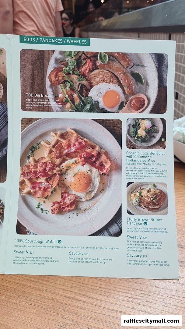 A menu page from Tiong Bahru Bakery featuring breakfast dishes like big breakfast, waffles, and pancakes.