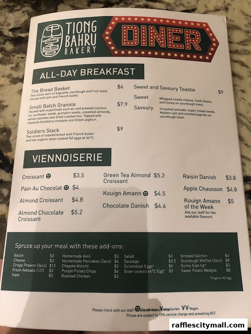 A menu from Tiong Bahru Bakery featuring all-day breakfast, viennoiserie, and add-on options.