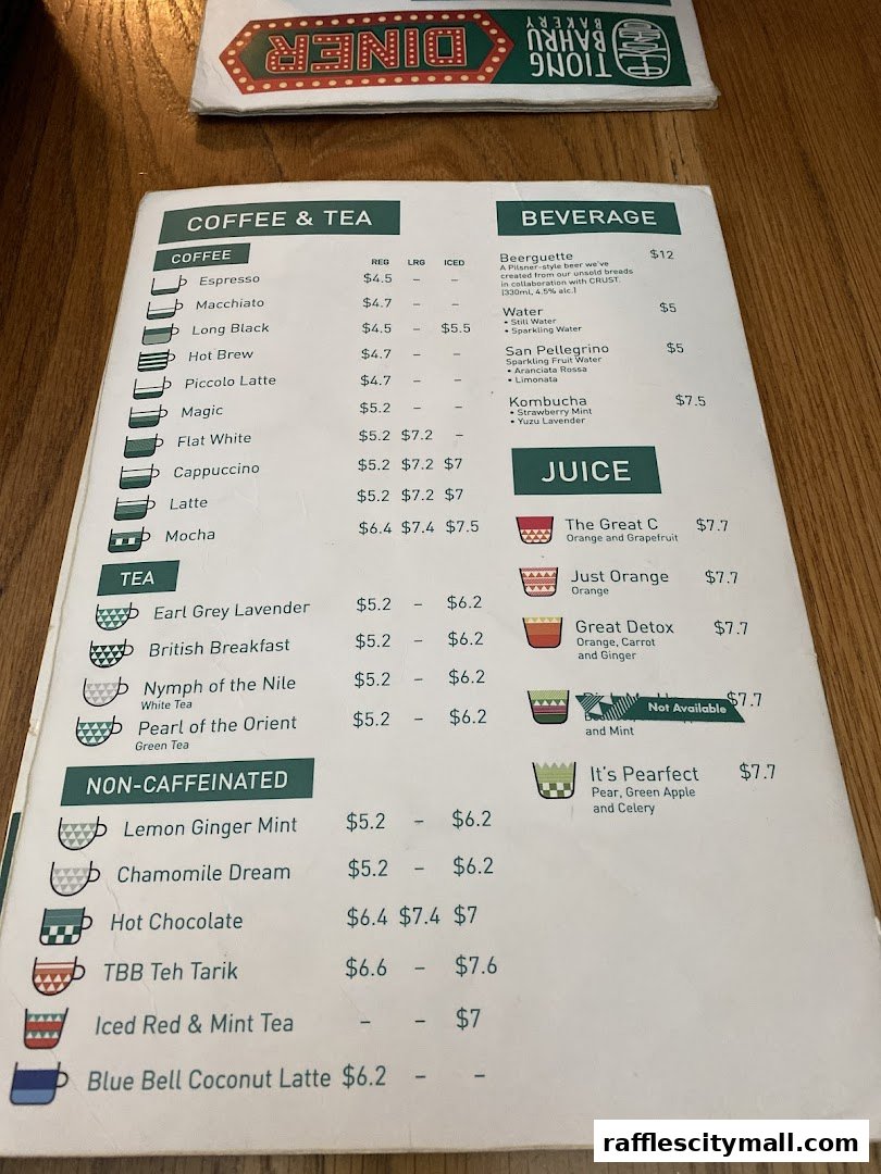 A menu from Tiong Bahru Bakery featuring coffee, tea, beverages, and juices with prices.