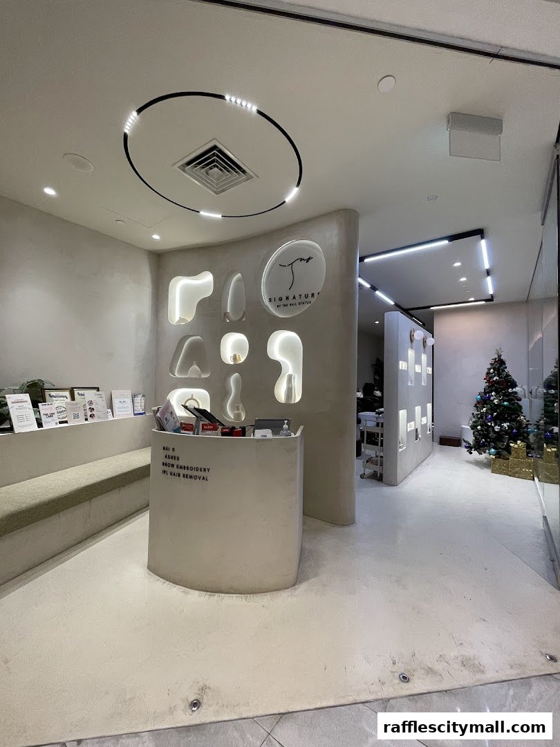 The reception area of TNS Signature By The Nail Status, featuring a modern design with a reception desk and seating.