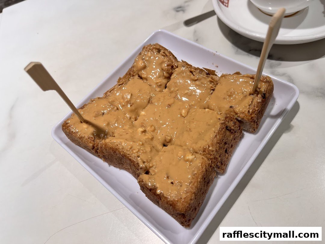 A plate of thick toast generously spread with peanut butter and topped with wooden skewers.