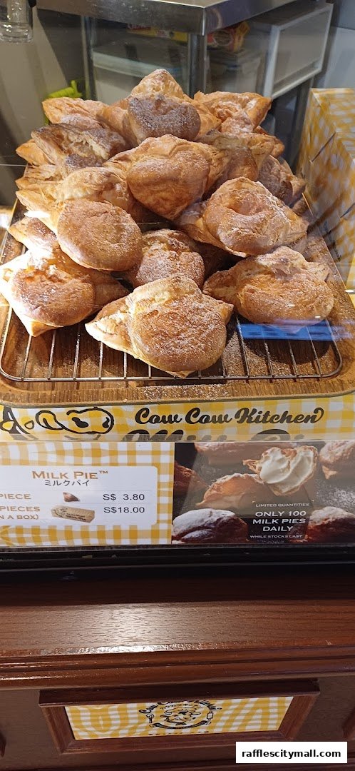 A display of freshly baked milk pies dusted with powdered sugar.