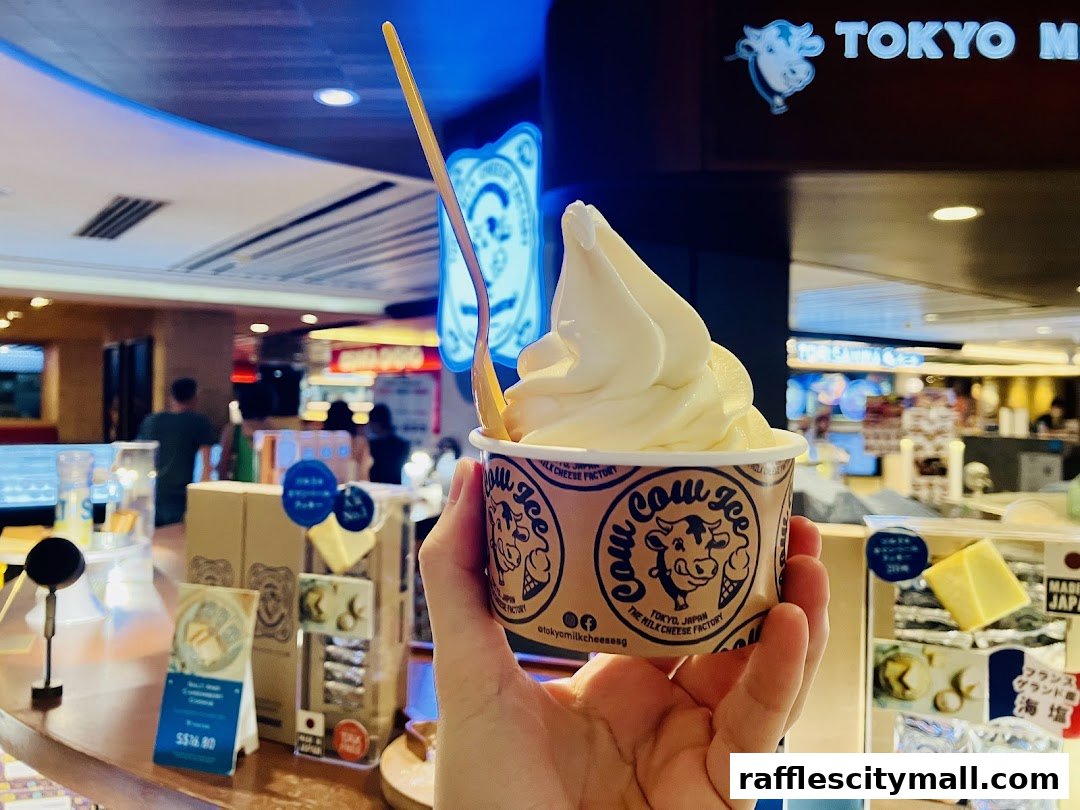 A hand holds a cup of soft-serve ice cream from Tokyo Milk Cheese Factory.