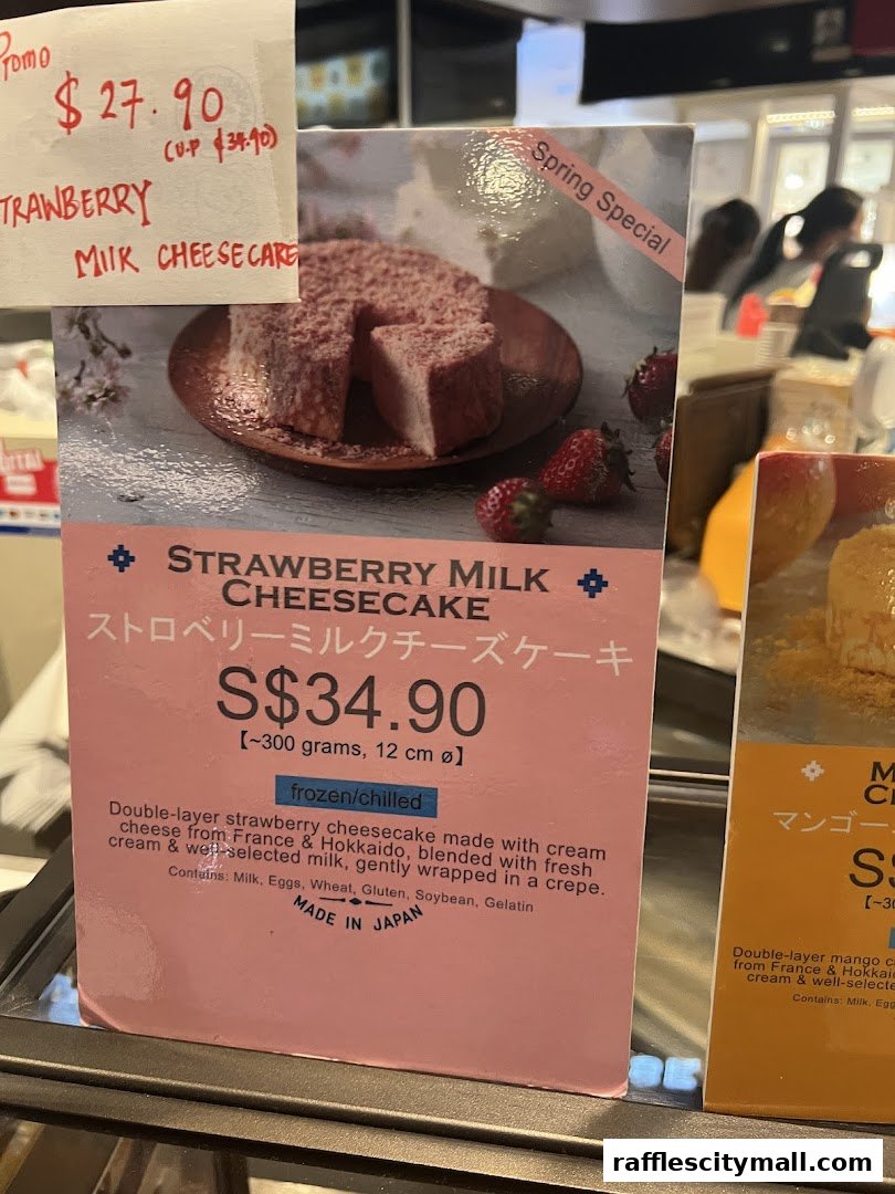 A sign displays a Strawberry Milk Cheesecake with its price and description.
