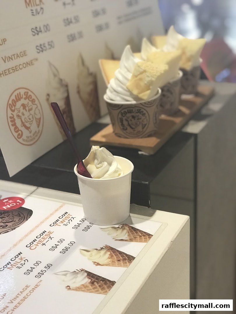 A display of soft serve ice cream cups and cones with a menu board in the background.