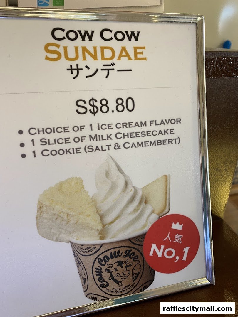 A sign advertising the Cow Cow Sundae with ice cream, cheesecake, and a cookie.