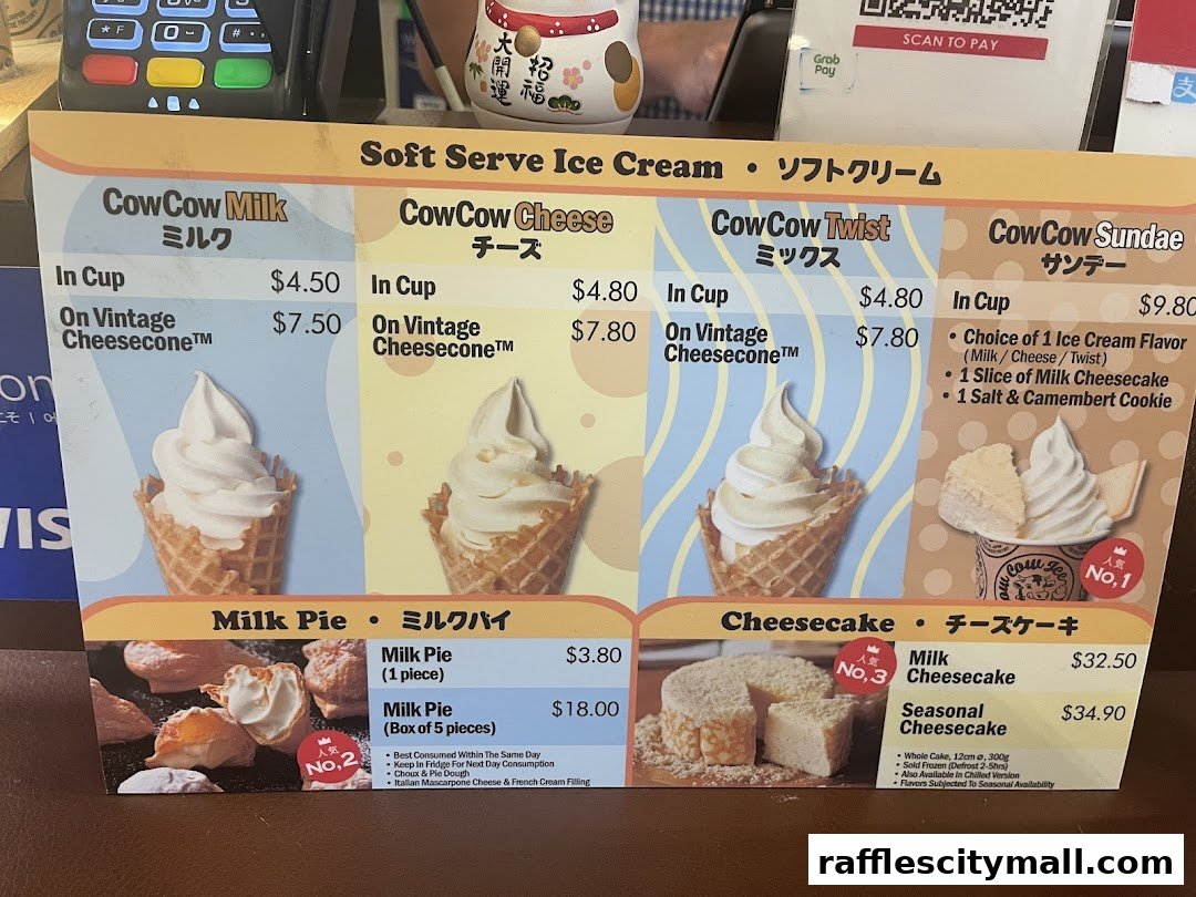 A menu board displaying various soft serve ice cream and cheesecake products from Tokyo Milk Cheese Factory.