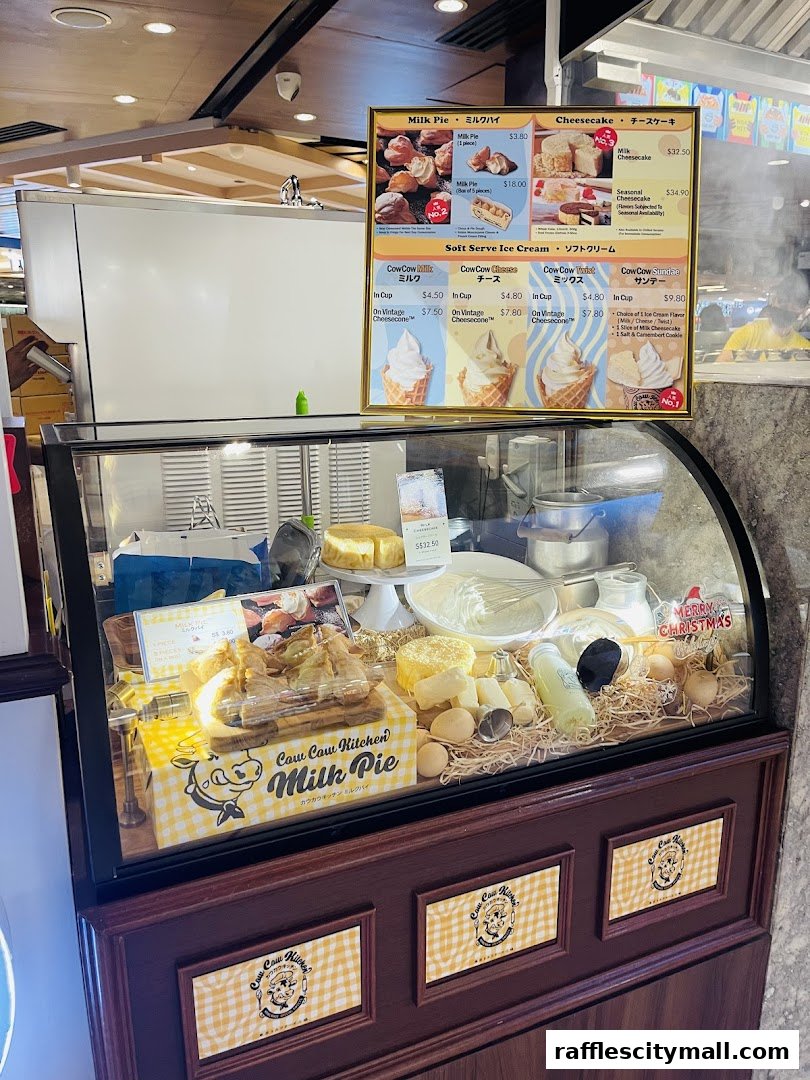 A display case filled with milk pies and soft-serve ice cream, with a menu board above.