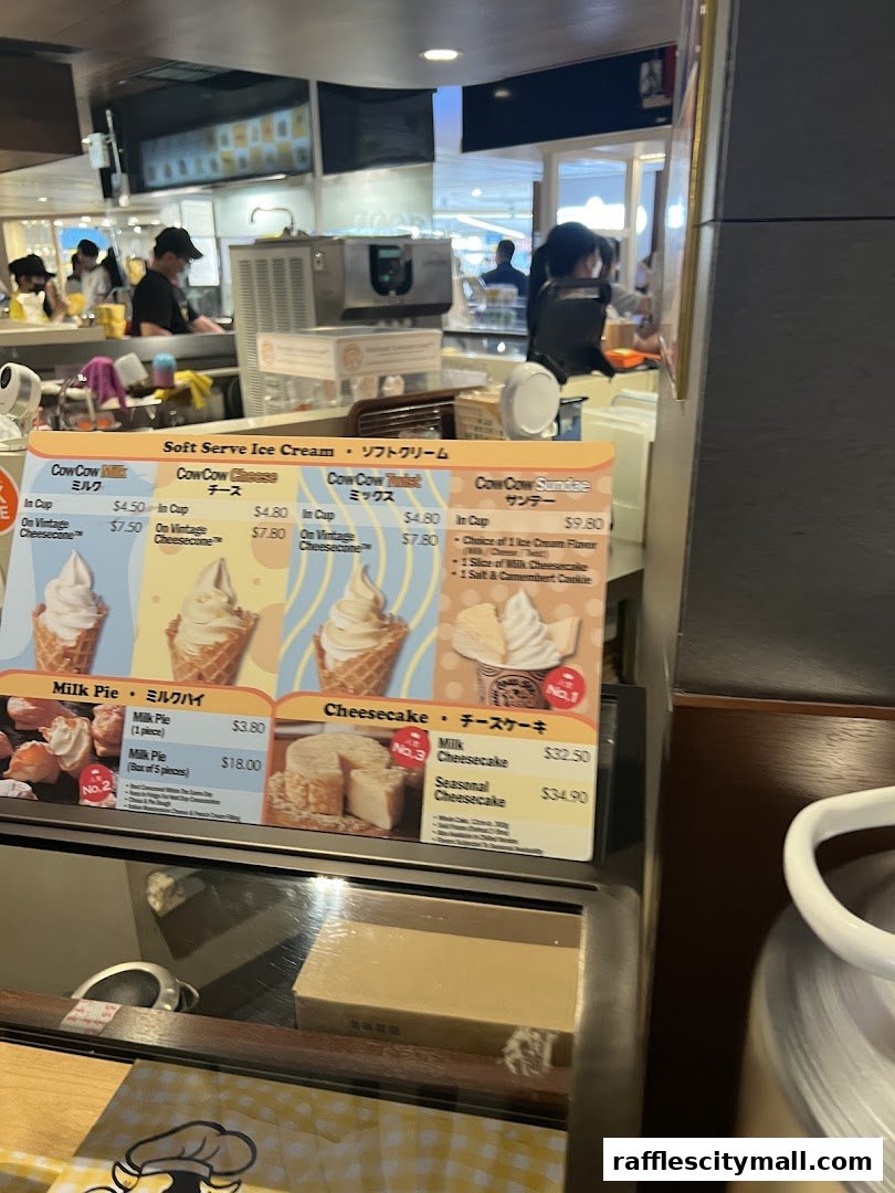 A menu board displaying soft serve ice cream, milk pie, and cheesecake options with prices.