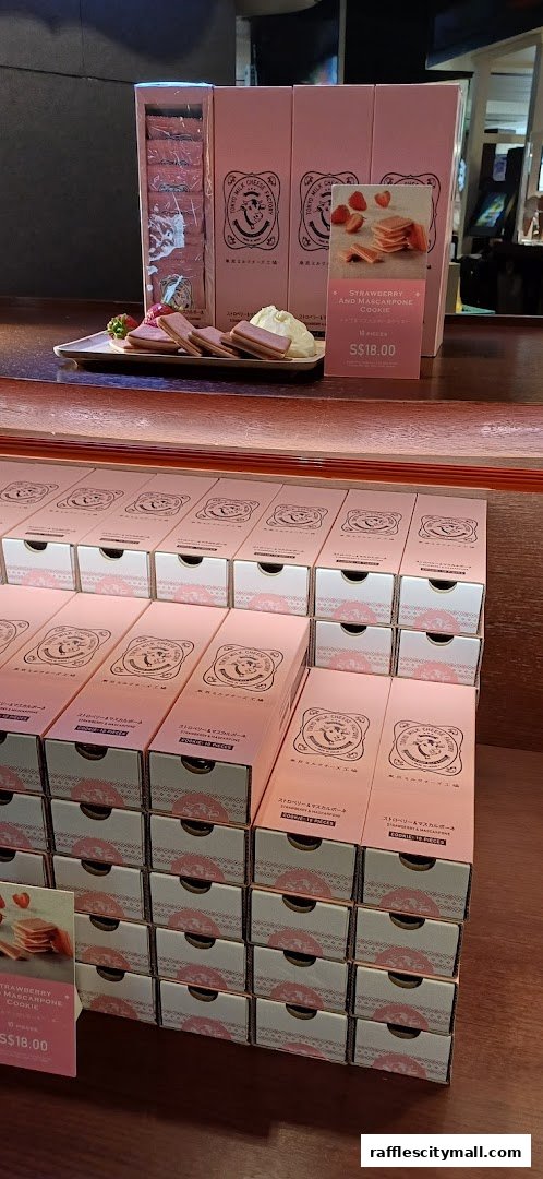 A display of pink boxes filled with Tokyo Milk Cheese Factory cookies, featuring strawberry and mascarpone flavor.