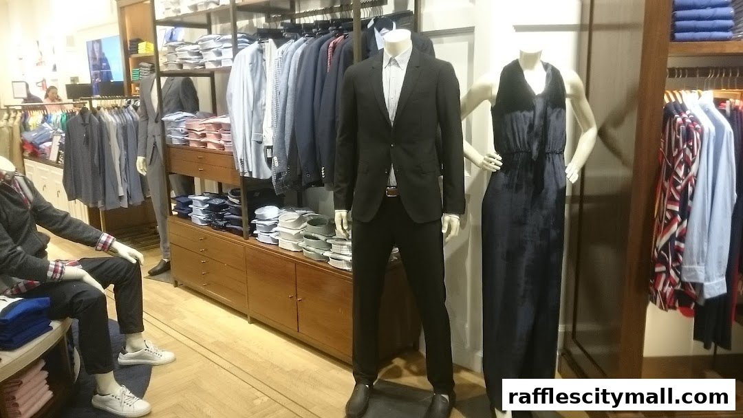 Mannequins display formal wear and casual outfits in a well-lit clothing store.