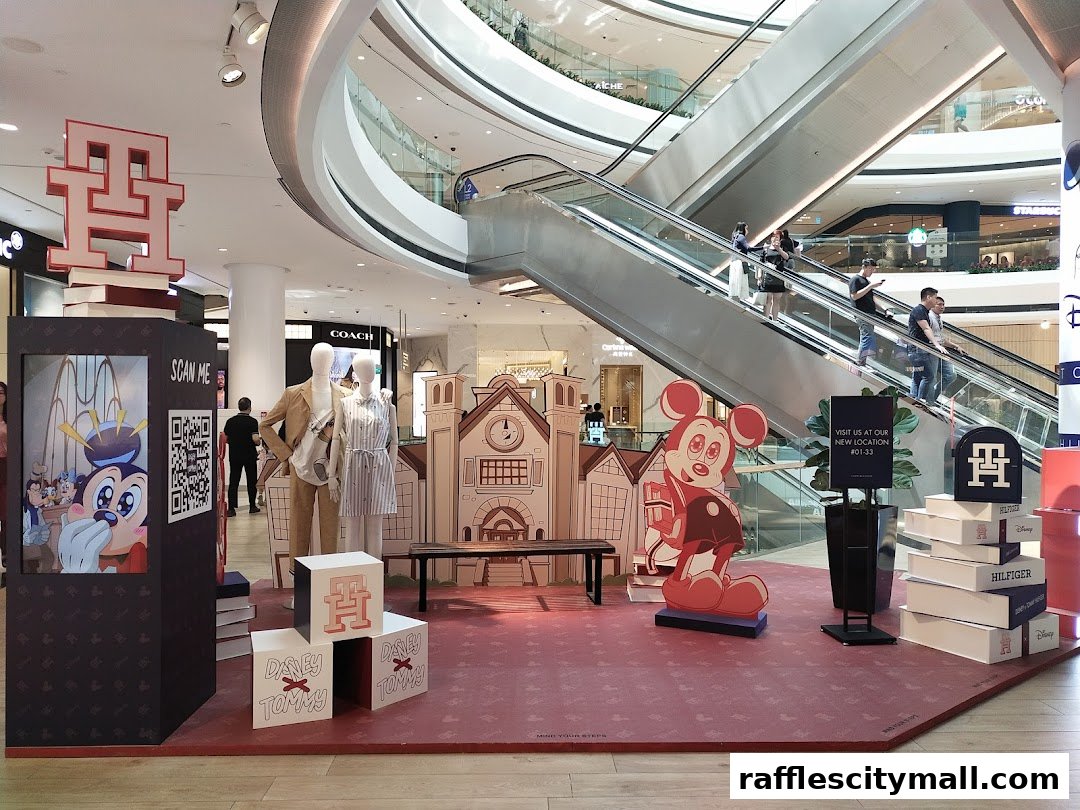 Tommy Hilfiger store display featuring Mickey Mouse, mannequins, and branding in a shopping mall.