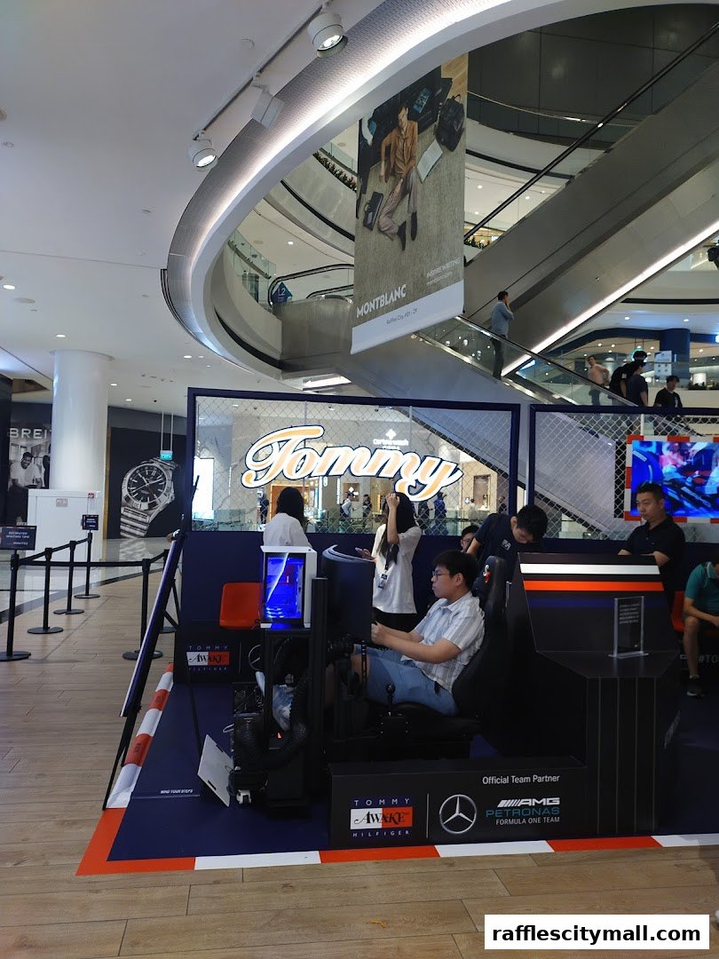 A racing simulator setup with Tommy Hilfiger branding and people interacting with it.