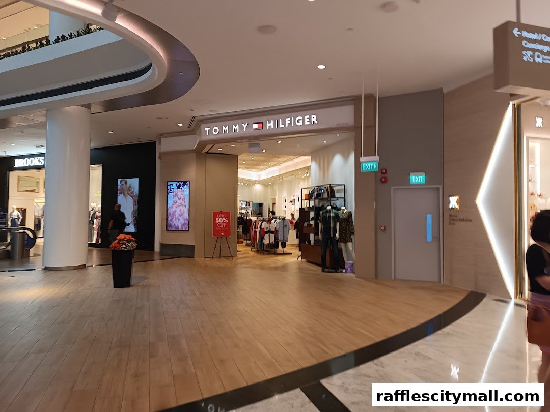 The entrance to the Tommy Hilfiger store in a modern shopping mall, with displays and signage visible.