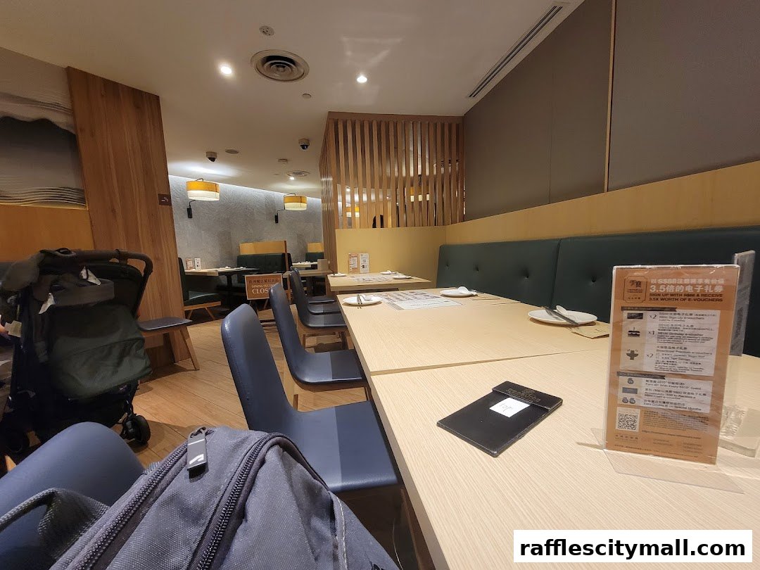 Interior of a restaurant with tables, chairs, and a stroller.