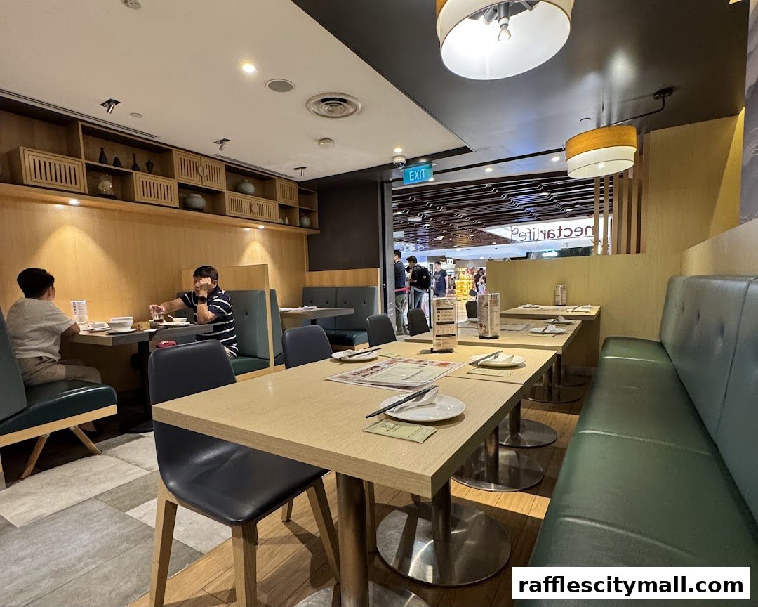 Interior of a restaurant with tables set for dining and people seated at one table.
