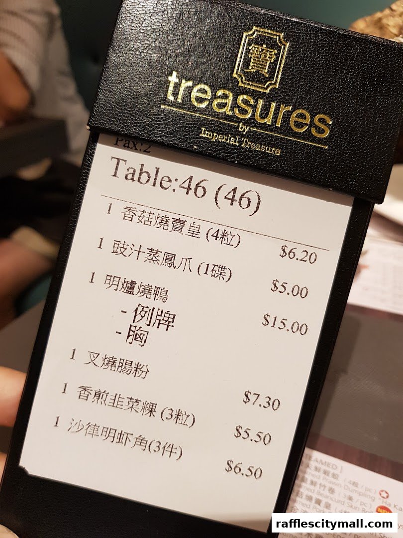 A close-up of a restaurant bill showing various dim sum items and their prices.