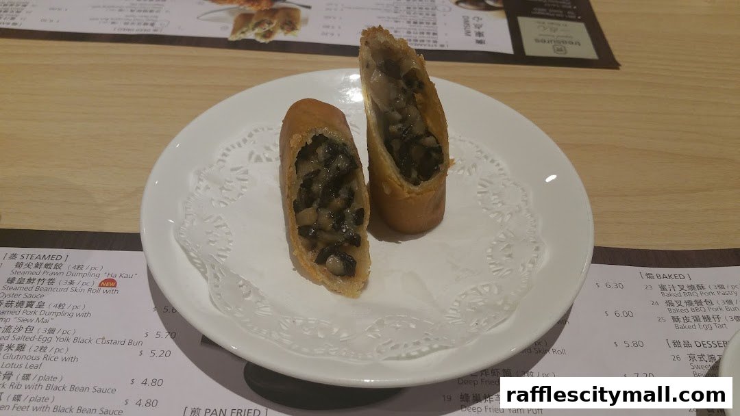 Two golden fried spring rolls filled with mushrooms are presented on a white plate with a doily.