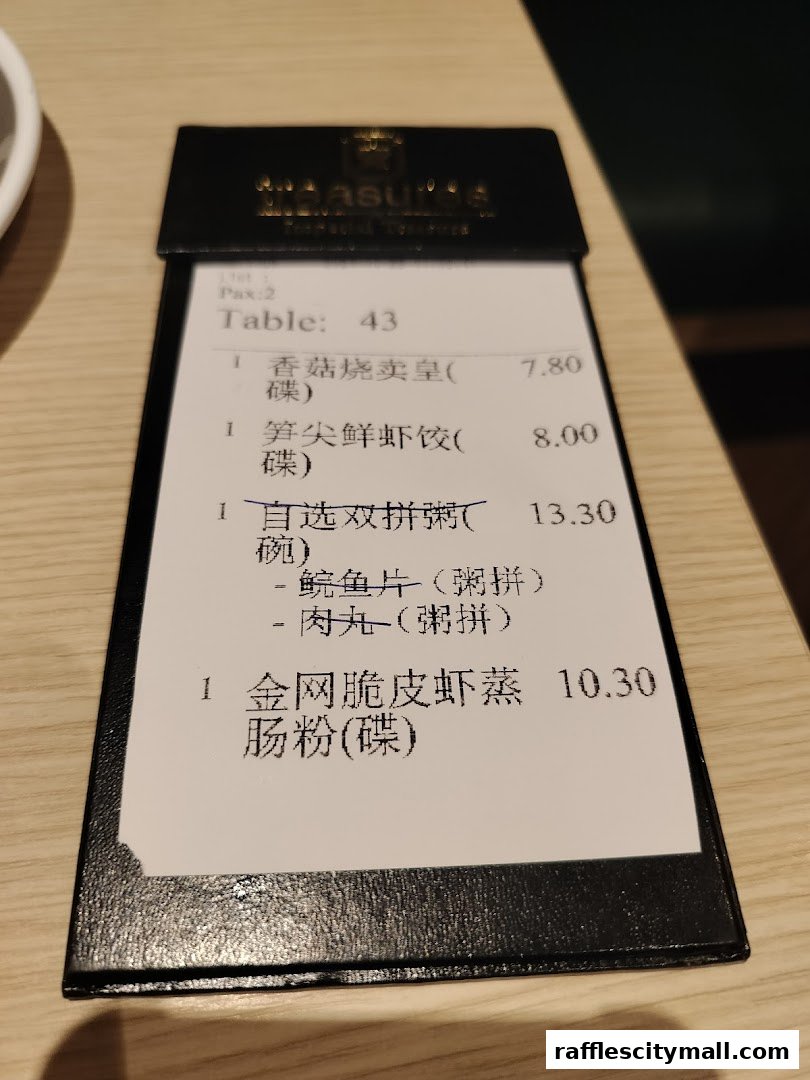 A close-up of a restaurant bill showing various dim sum items and their prices.
