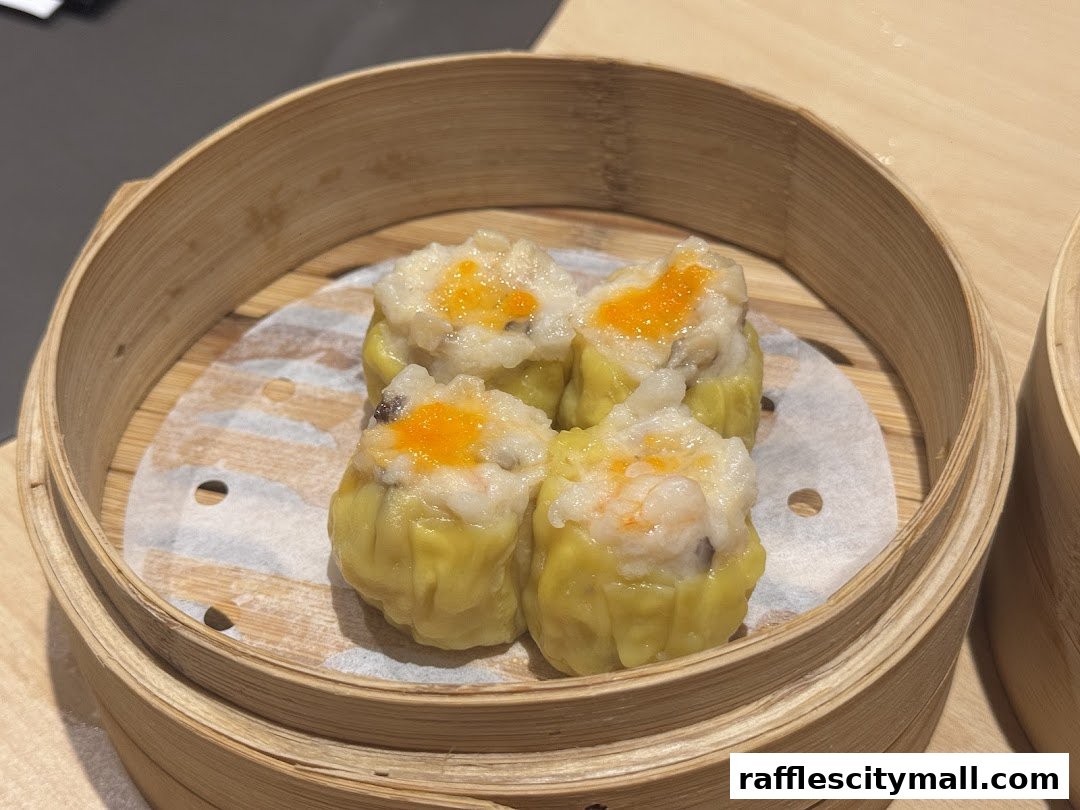 A close-up of four delicious dim sum dumplings in a bamboo steamer.