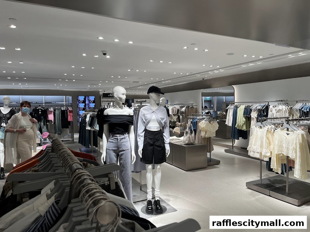 Interior view of a clothing store with mannequins and racks of apparel.