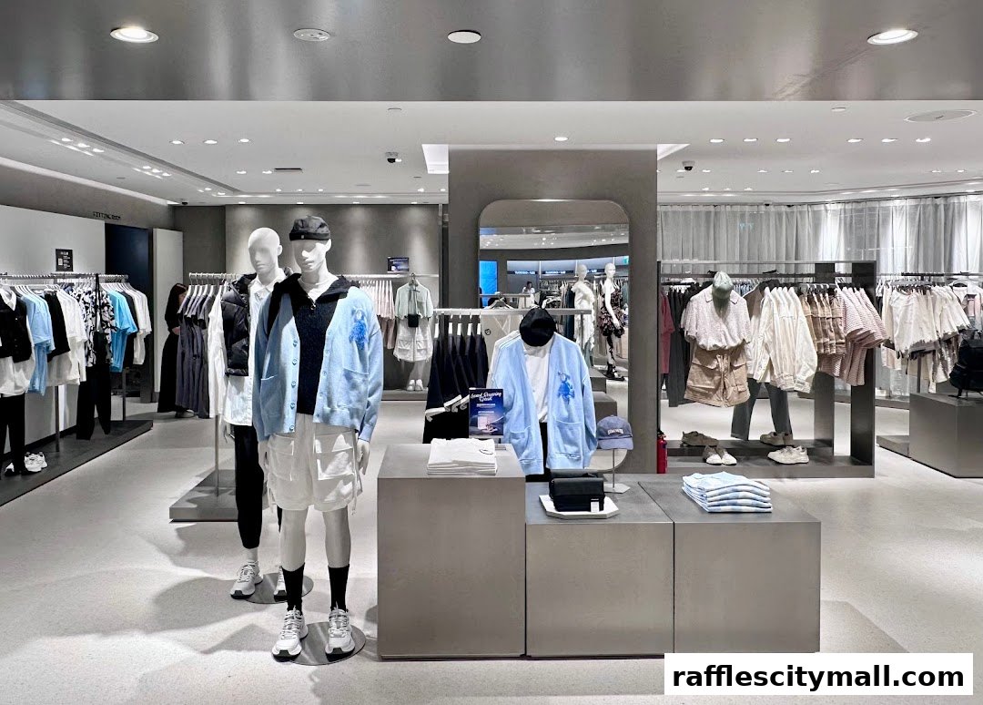 Mannequins display stylish casual wear inside a modern clothing store.