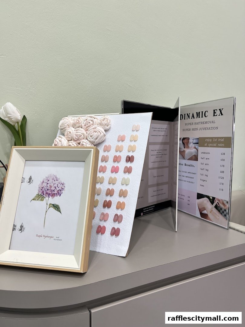 A display with nail color swatches, a framed hydrangea print, and a price list for beauty services.