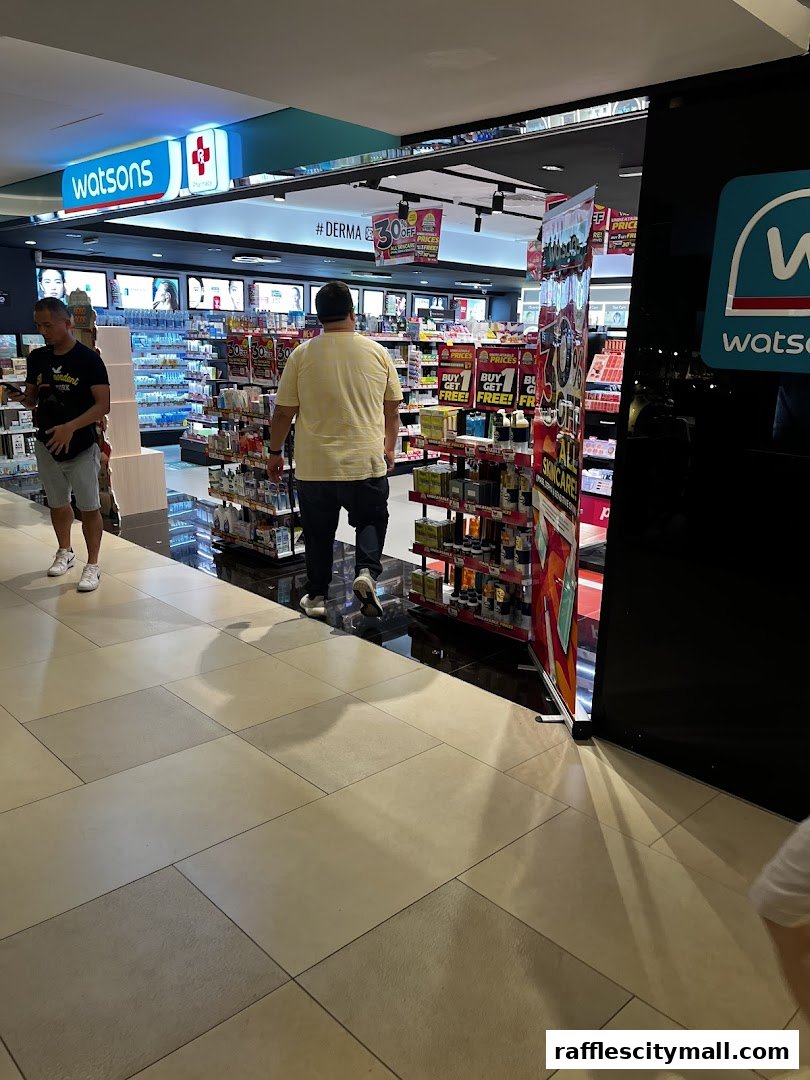View of a Watsons pharmacy and GNC store entrance with products displayed.