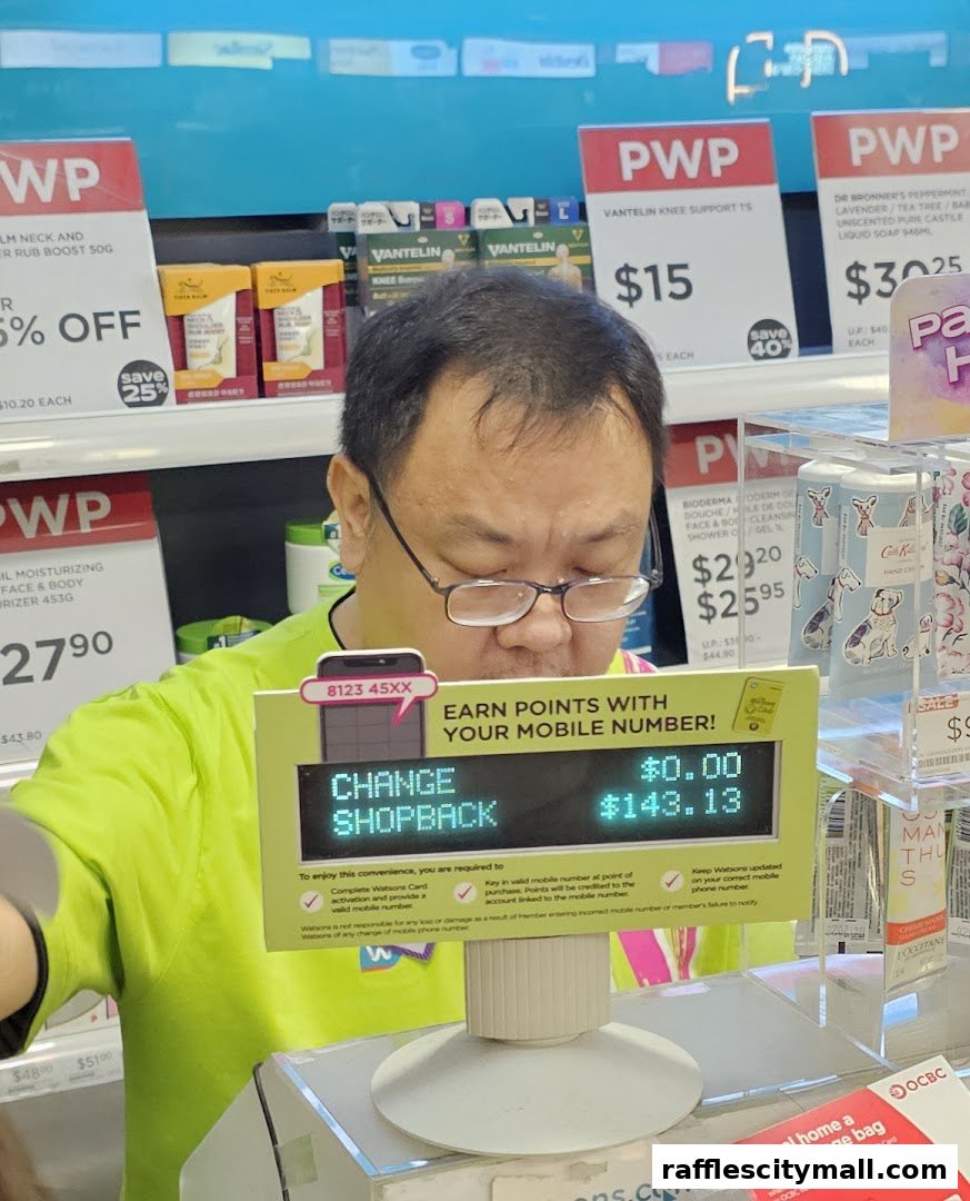 A Watsons employee stands at a counter with a digital display showing shopback points.