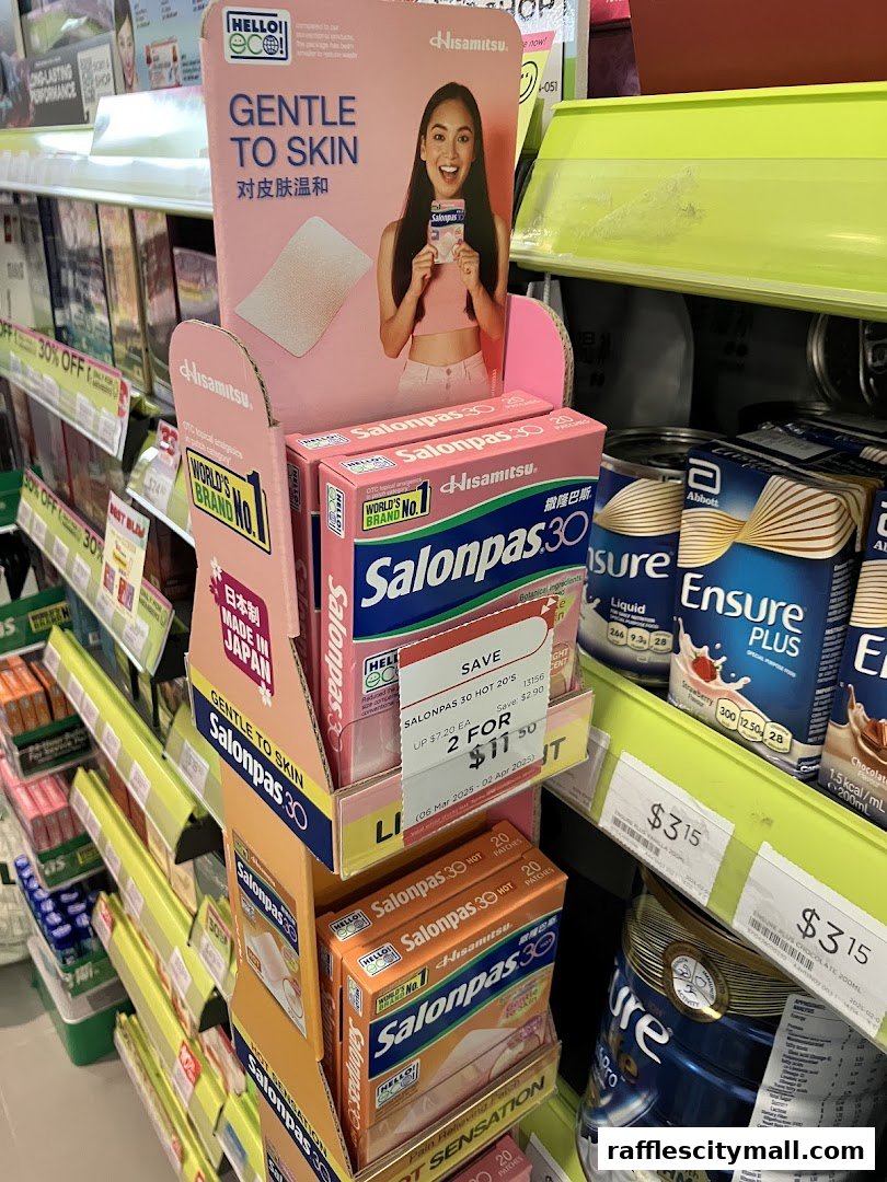 A display of Salonpas pain relief patches and Ensure nutritional drinks in a retail store.