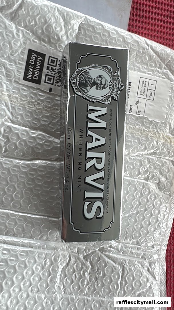 A box of Marvis Whitening Mint toothpaste is shown, packaged for delivery.