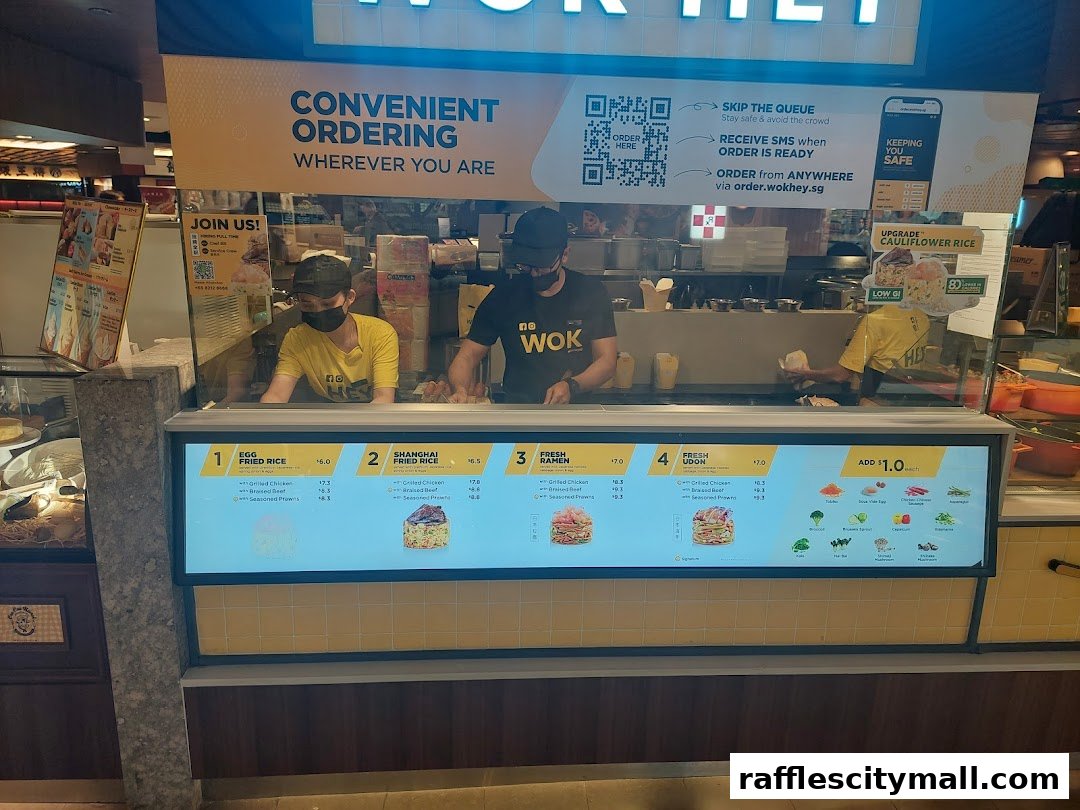 A digital menu board displaying various Wok Hey dishes and ordering information.