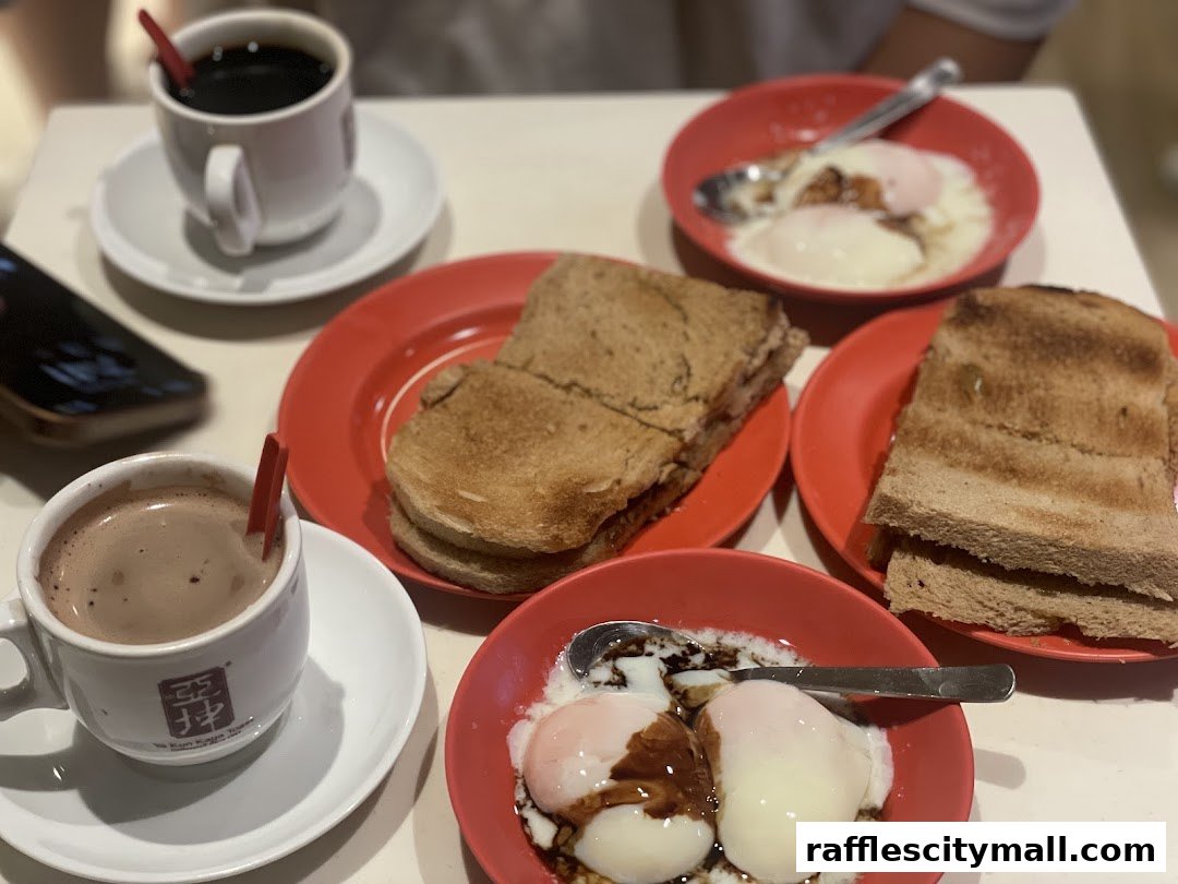 A table setting with kaya toast, soft-boiled eggs, and coffee at Ya Kun Kaya Toast.