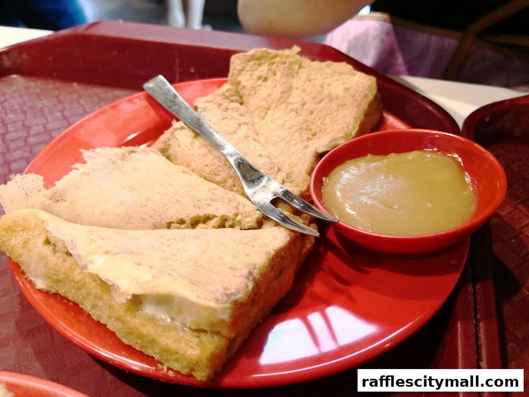 A close-up of Ya Kun Kaya Toast's signature kaya toast with a side of kaya dip.