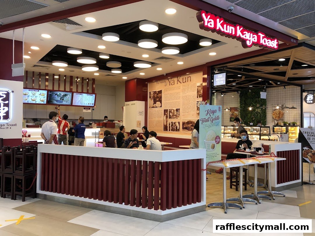 Interior view of a Ya Kun Kaya Toast restaurant with customers and staff.
