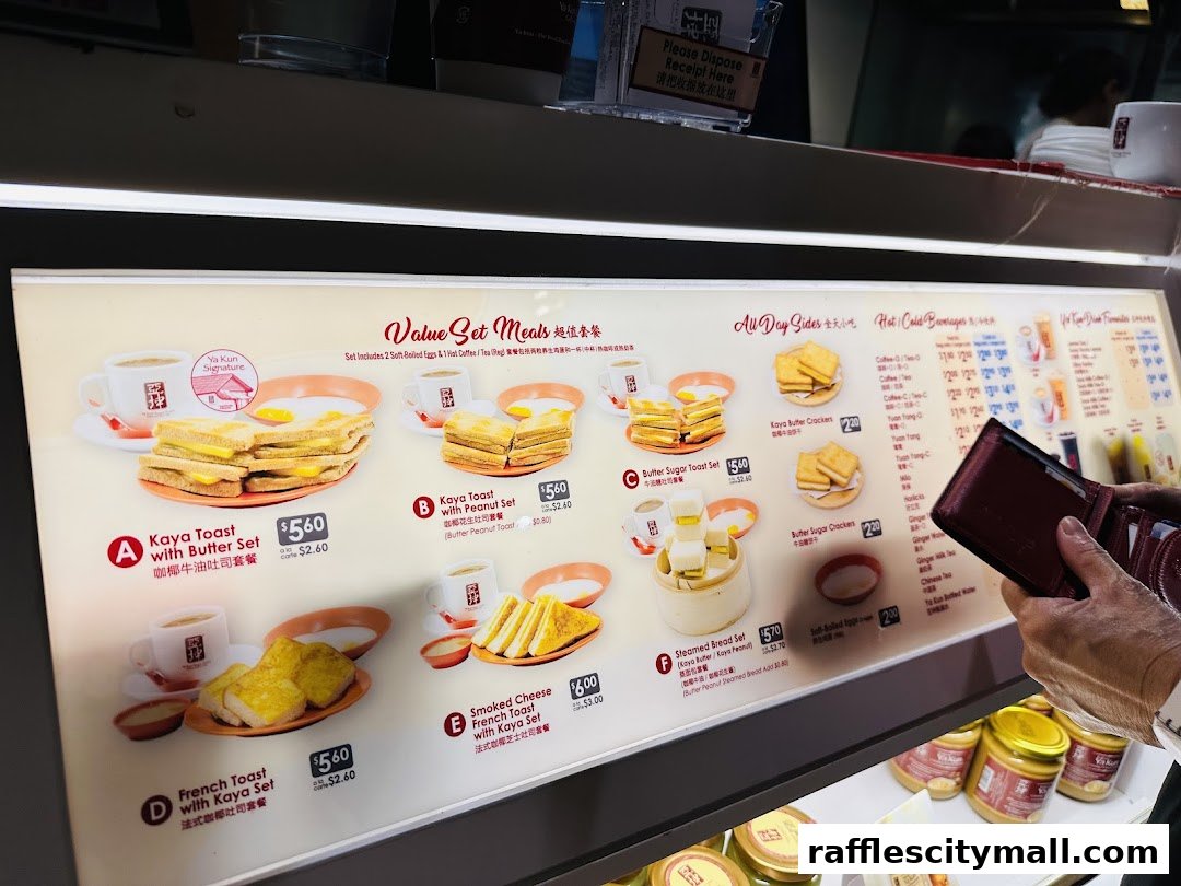 A menu board displaying various set meals and side dishes from Ya Kun Kaya Toast.