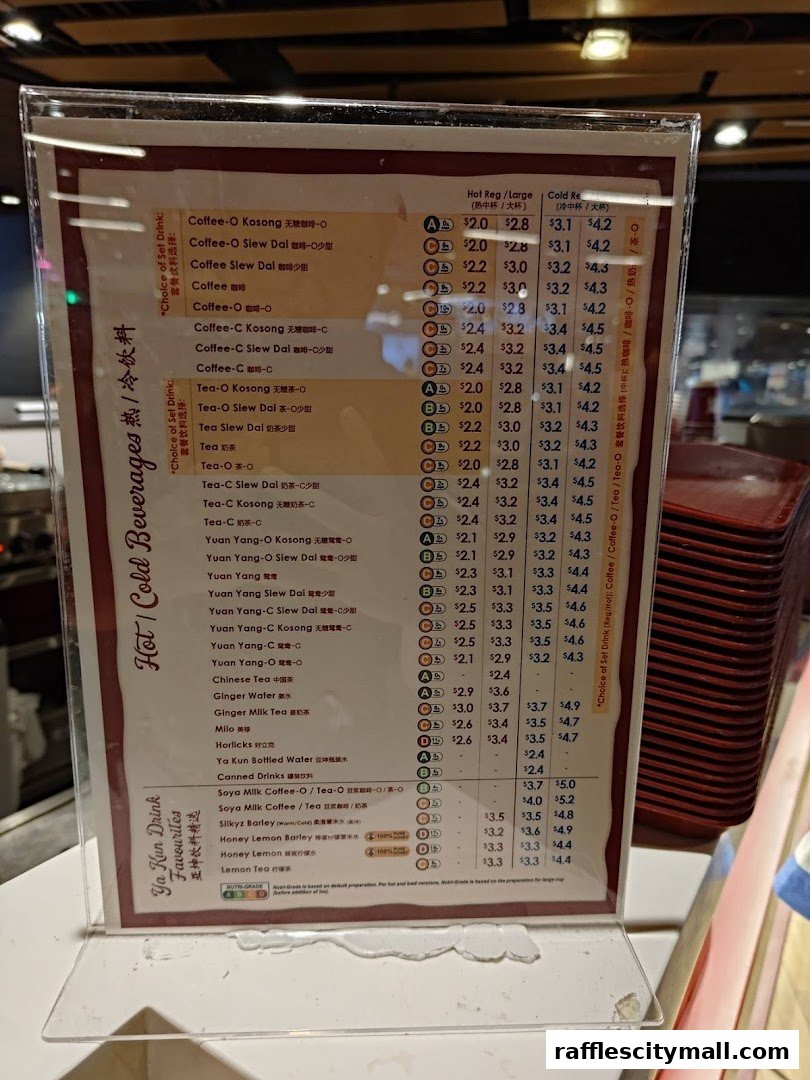 A menu board displaying various hot and cold beverages with prices at Ya Kun Kaya Toast.