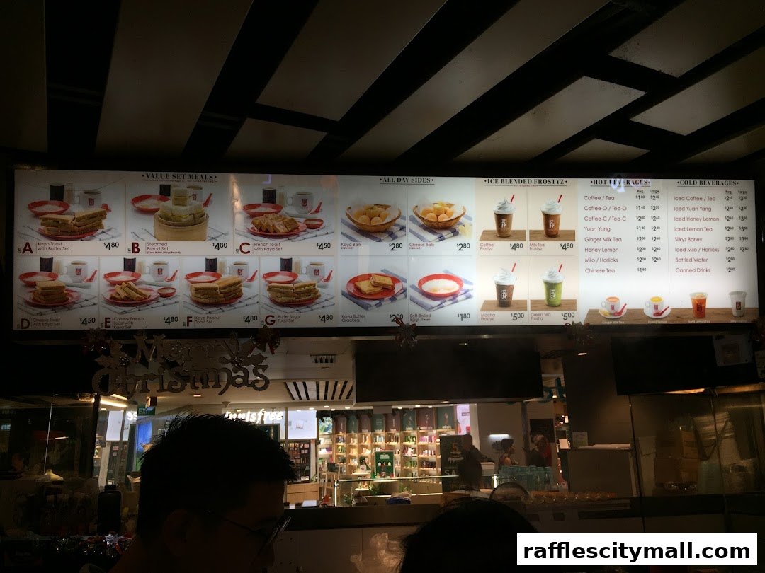 A menu board displaying various set meals, sides, iced drinks, hot beverages, and cold beverages.
