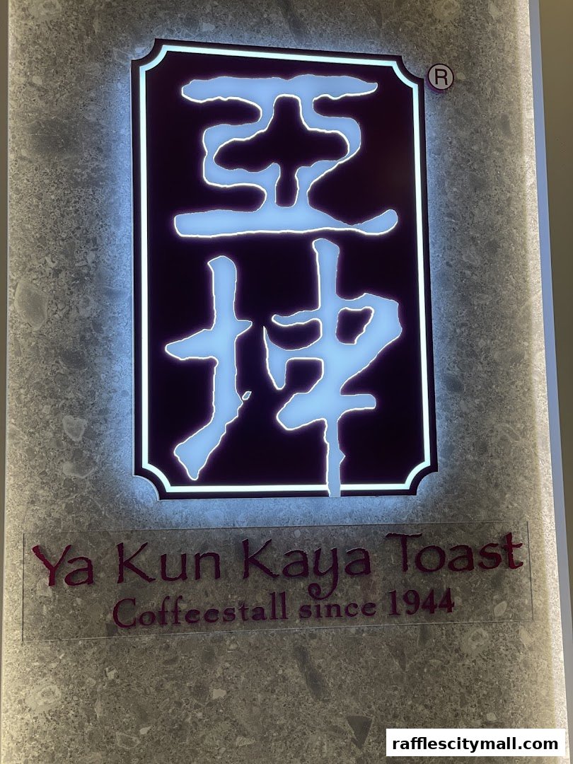 The illuminated sign for Ya Kun Kaya Toast, a coffee stall established in 1944.