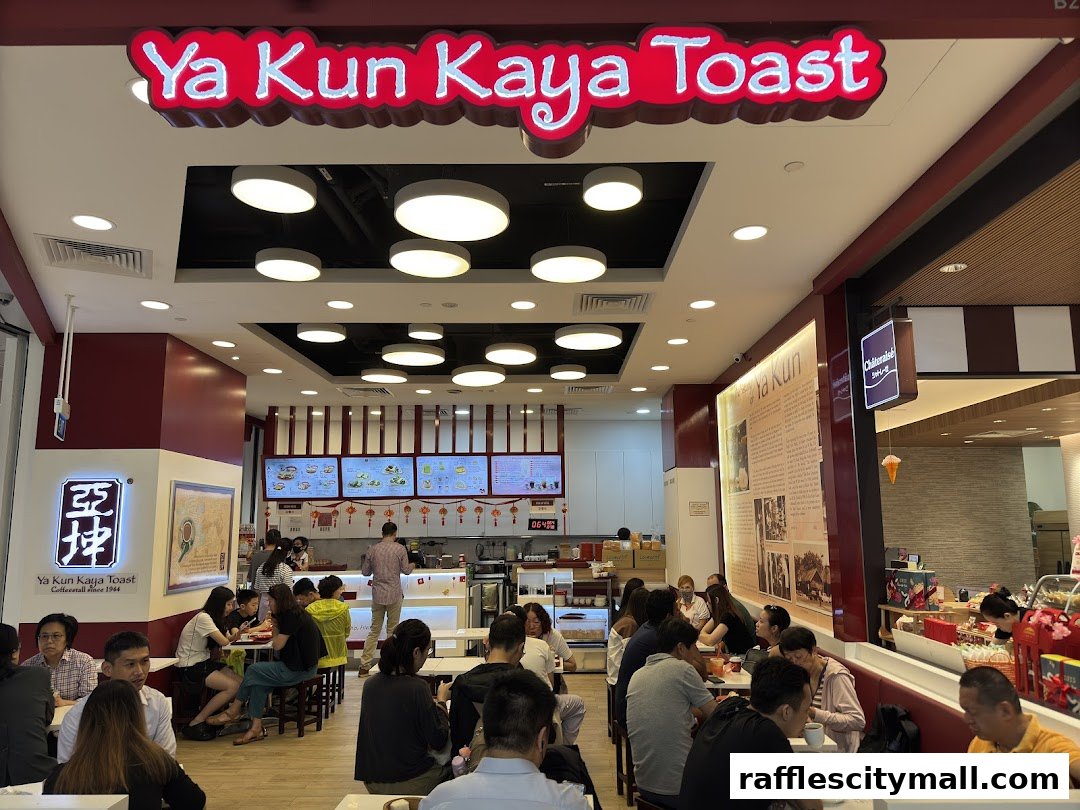 Interior view of Ya Kun Kaya Toast with customers dining and a prominent sign.