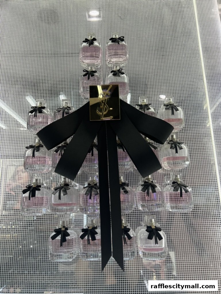 A display of YSL perfume bottles with a large black bow and gold logo.