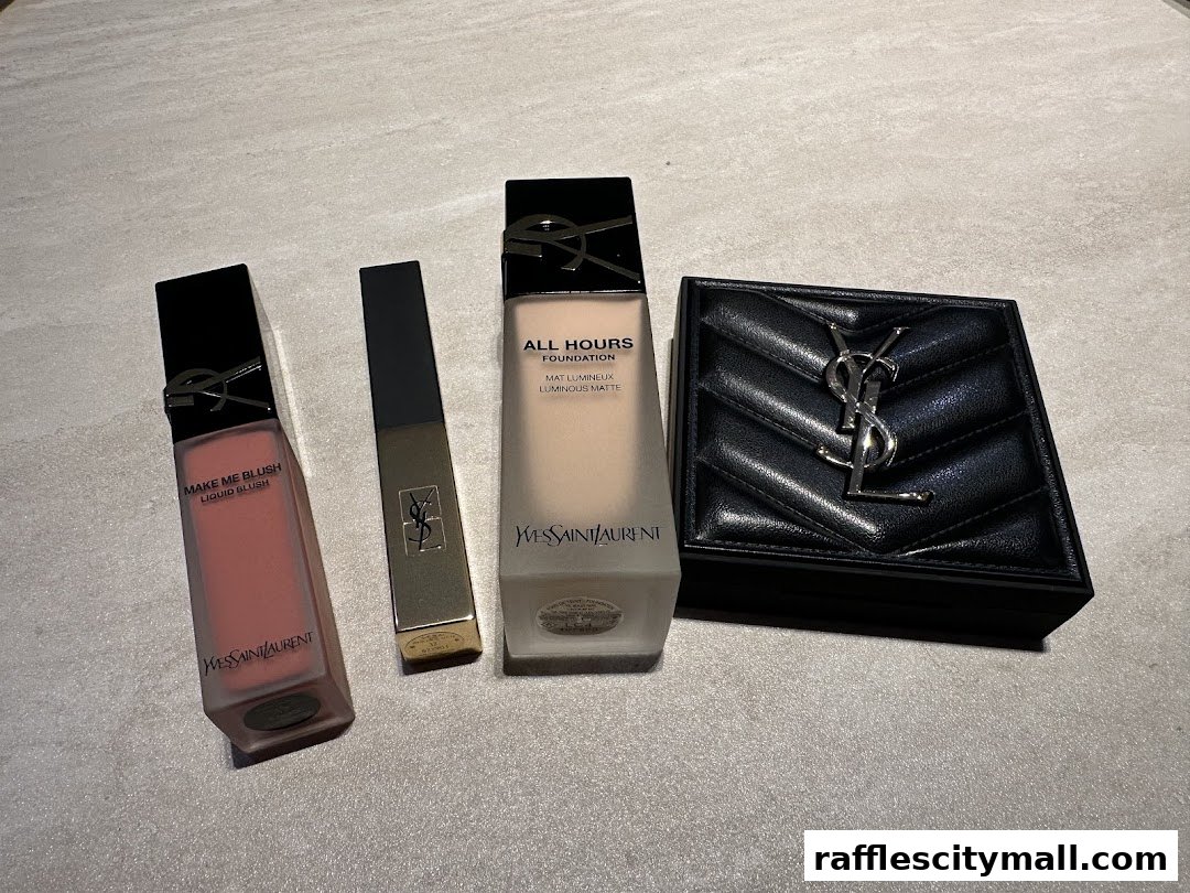 Assortment of YSL Beauty makeup products including liquid blush, foundation, and a compact.